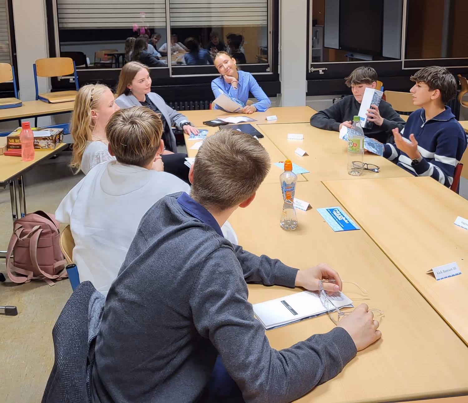 Schüler:innen reden im Klassenraum.