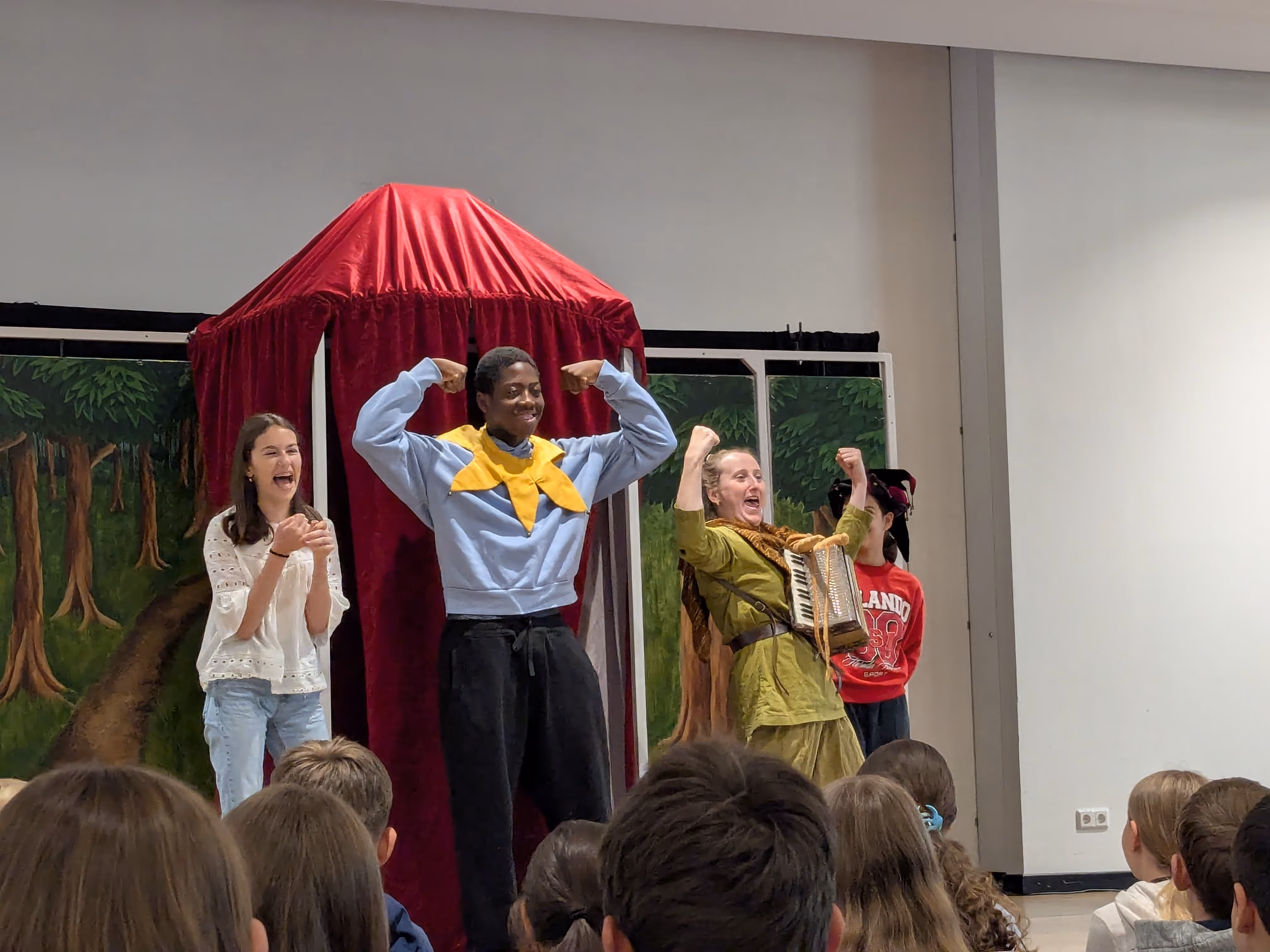 Die englische Theatergruppe und ein Schüler der AES auf der Bühne.