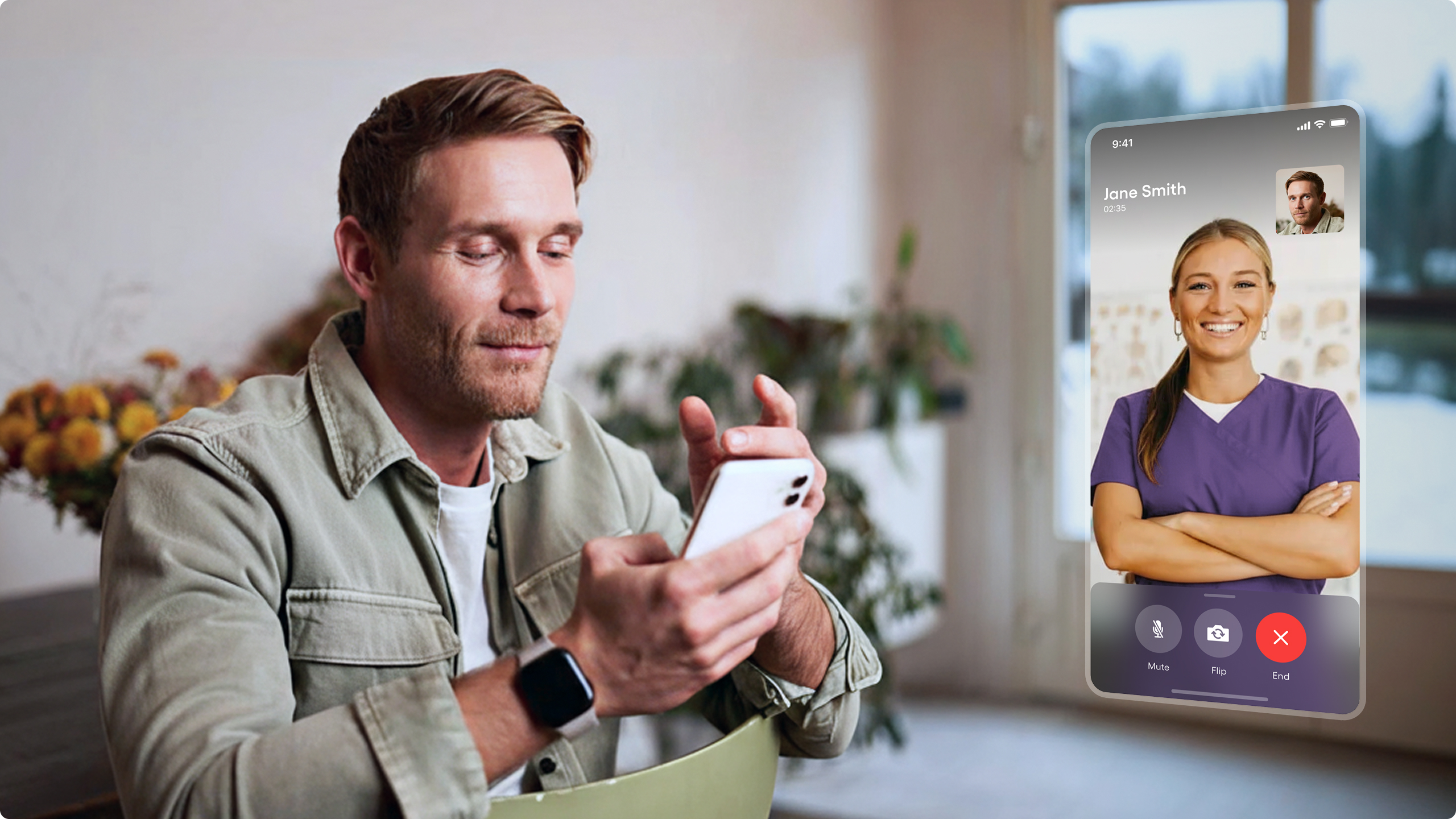 Man sitting indoors holding a smartphone, video calling a male doctor wearing glasses and a stethoscope on the screen.