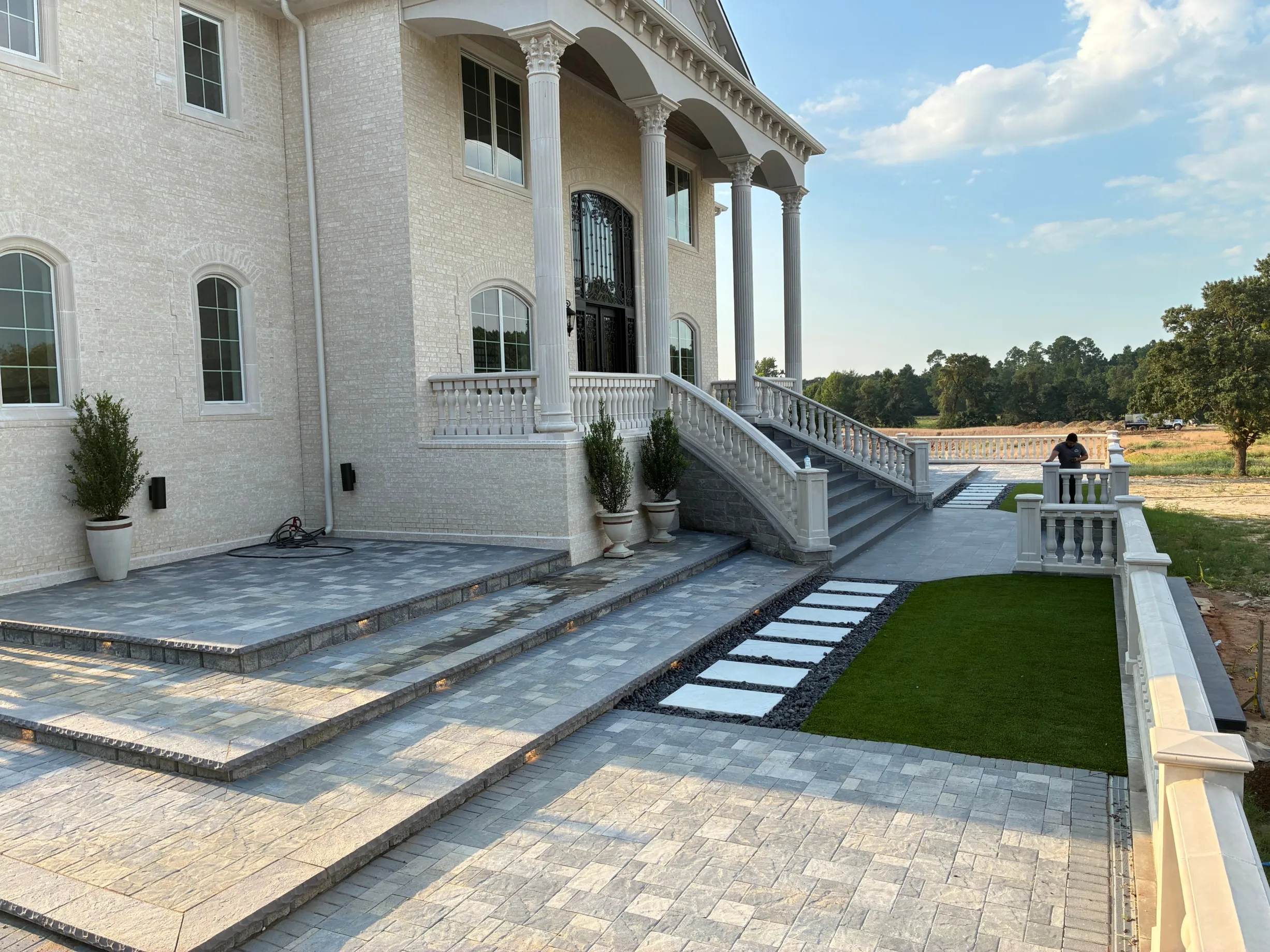 Custom paver walkway and stone steps leading to home entrance