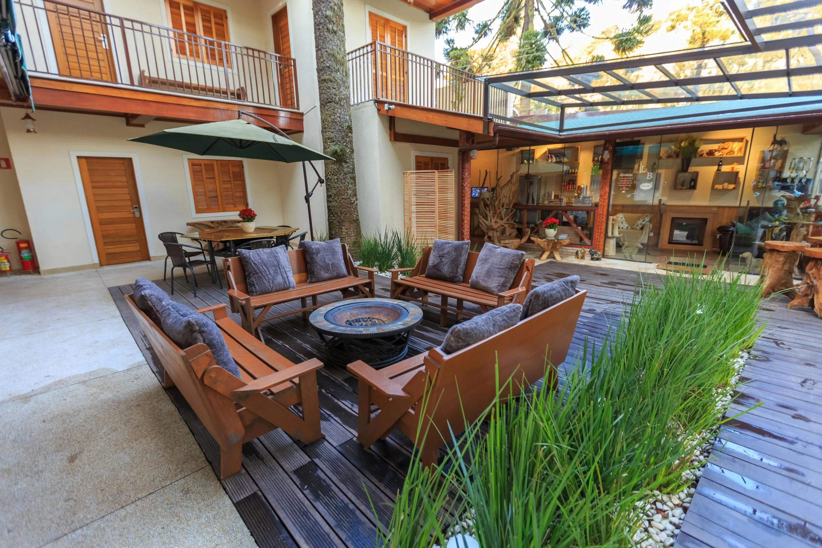 Covered outdoor patio with lounge seating, fire pit, and pergola