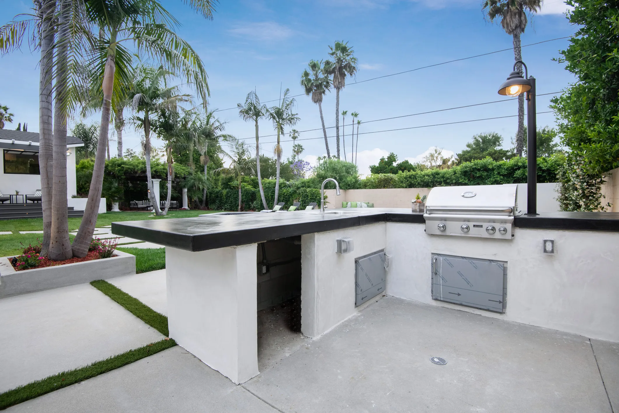 Custom outdoor kitchen with built-in grill and stone countertops