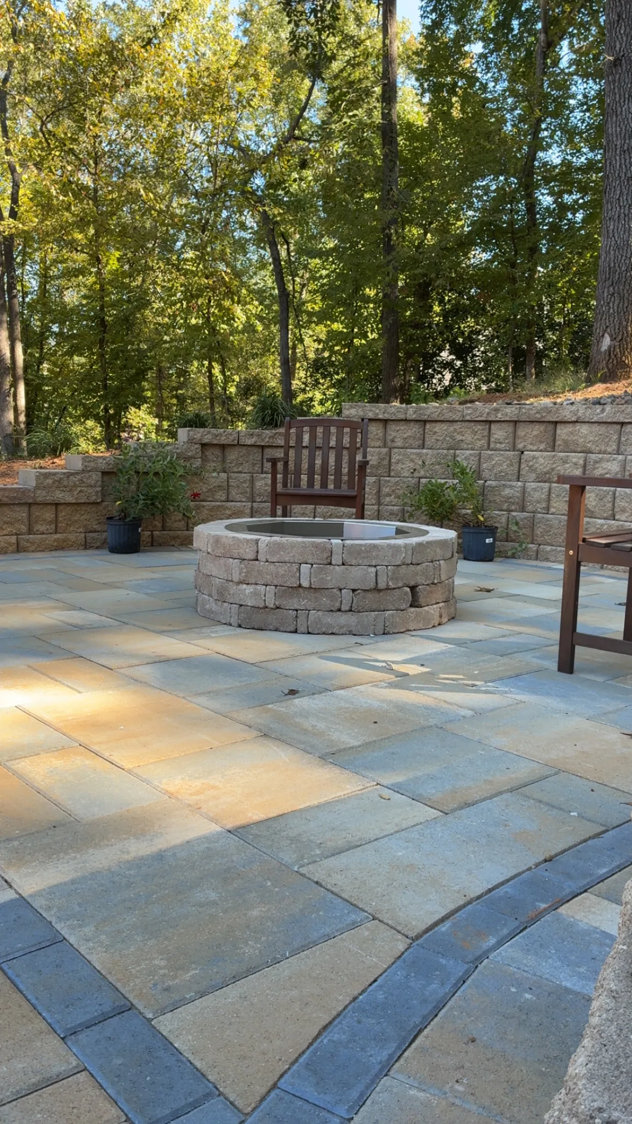 Stone paver patio with custom circular fire pit and seating area