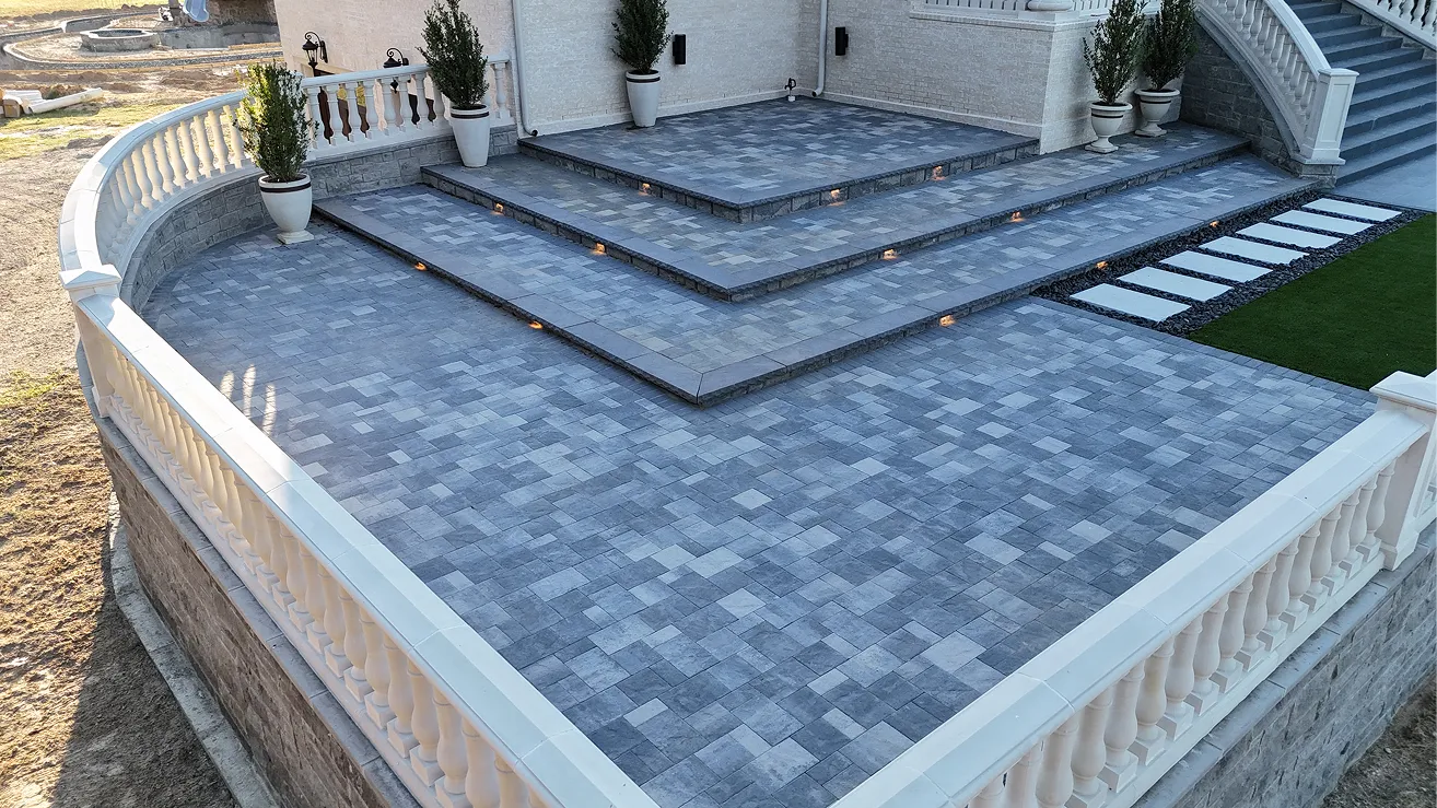 Custom multi-level paver patio with wide steps and retaining walls
