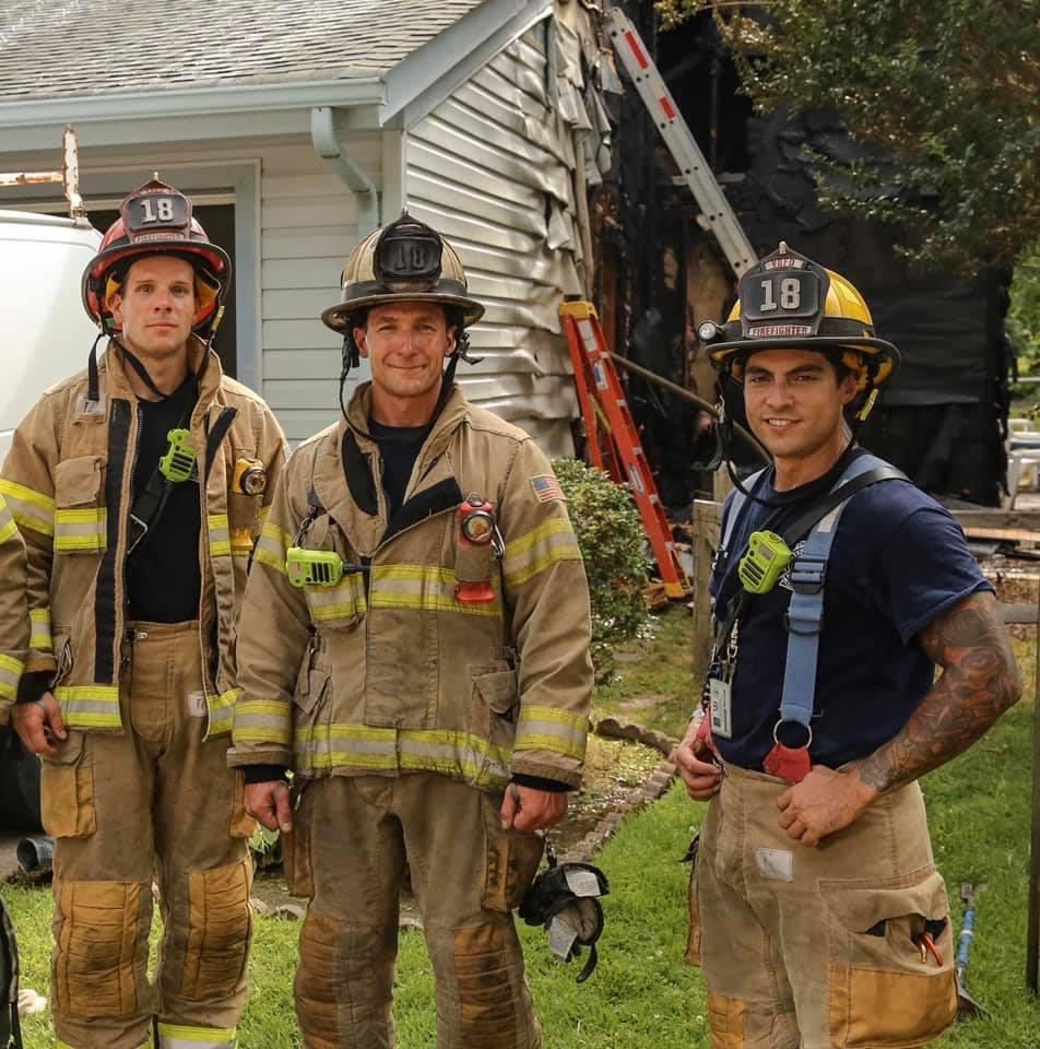 Matt Chiaverotti next to other firefighters at house fire.