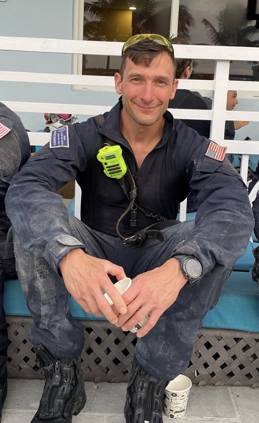 Matt Chiaverotti in uniform sitting down smiling.