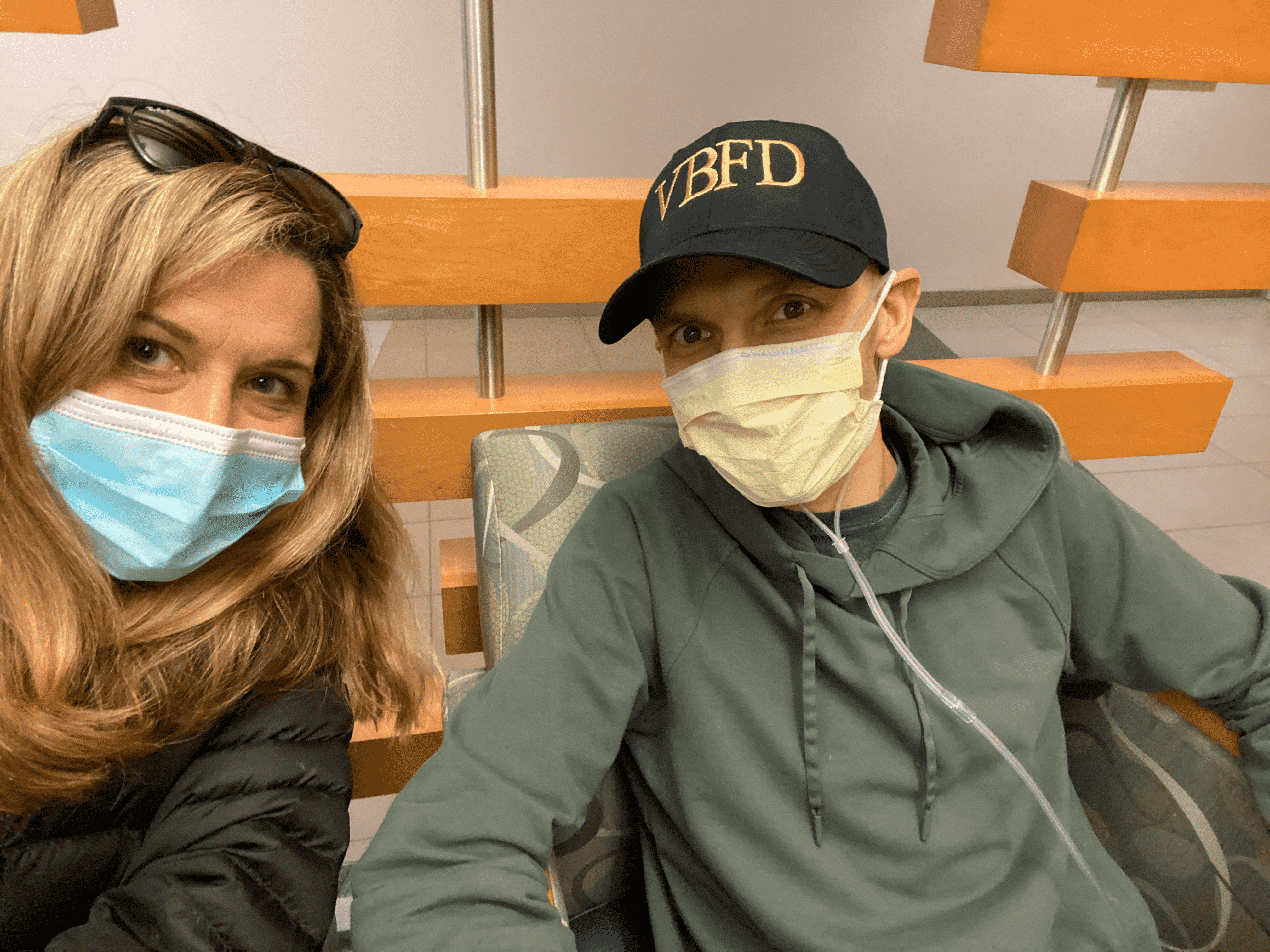 Matt Chiaverotti sitting down receiving treatment with wife Sara.