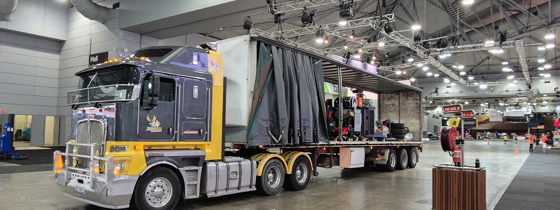 A RoadBees linehaul truck is parked inside the Brisbane Convention Center as it unloads sensitive freight.