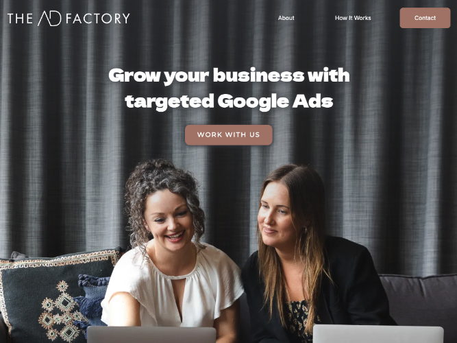 Two women smiling and working on laptops in front of a gray curtain with text promoting Google Ads business growth.