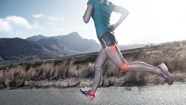Runner on a mountain road with highlighted hip, knee, and foot areas.