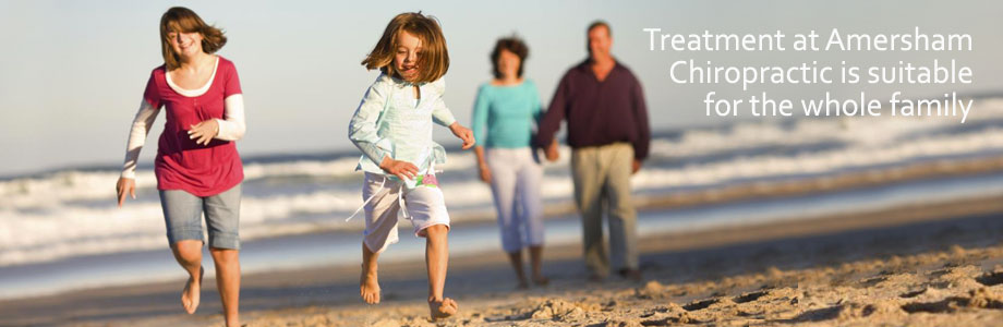 Four people walking and running along a beach; text reads, “Treatment at Amersham Chiropractic is suitable for the whole