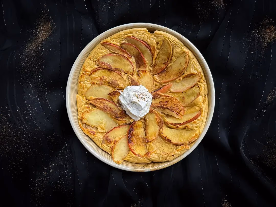 The big apple pancake is topped with a large scoop of Boursin.