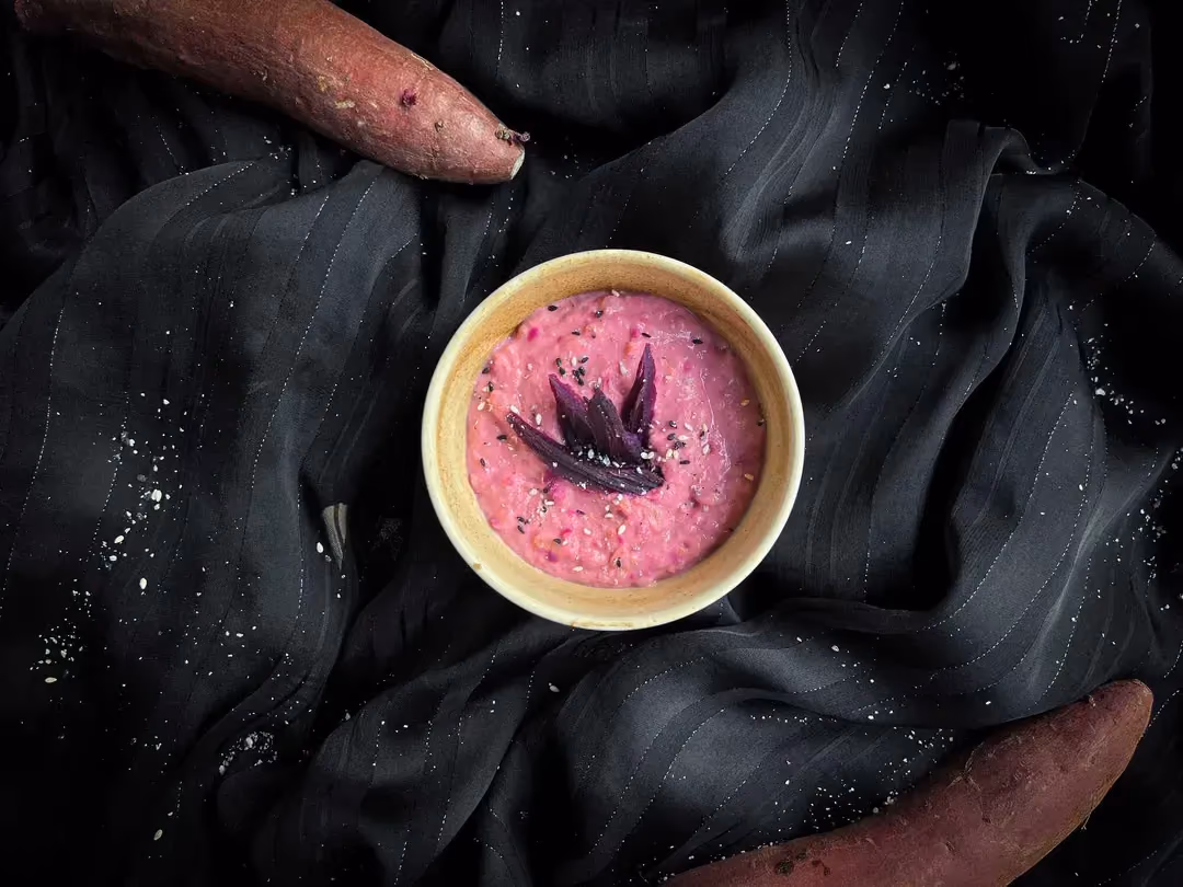 A small white stoneware bowl holds the express sweet potato bowl recipe. You can see the root vegetable's characteristic pinkish color.
