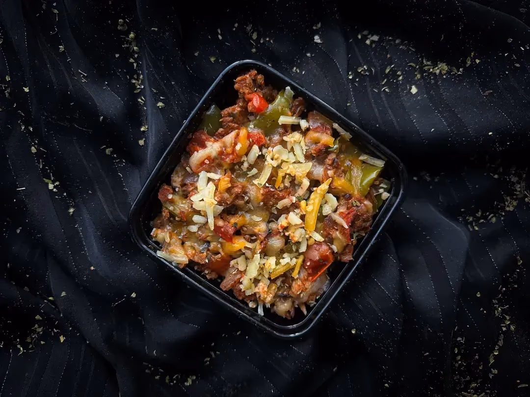A square dish is used to present the veggie pizza-style bowl recipe.