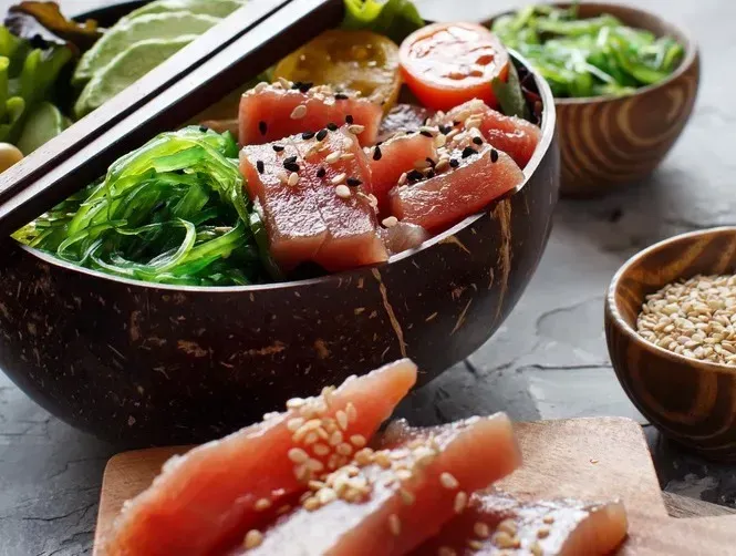 In a large bowl is a konjac chirashi made with thin slices of fresh raw tuna, konjac pearls, avocado, and lemon.