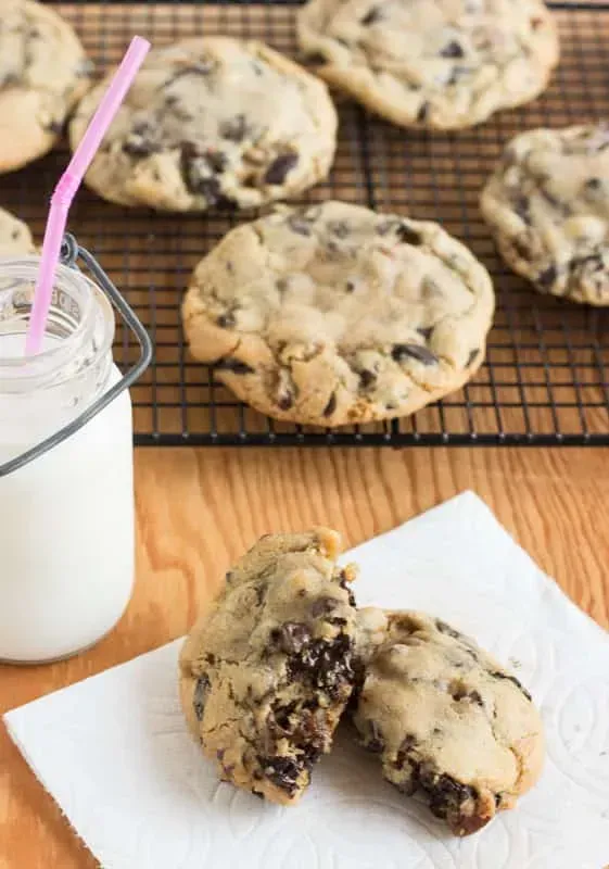 Chocolate chip cookies are placed on a wire rack.