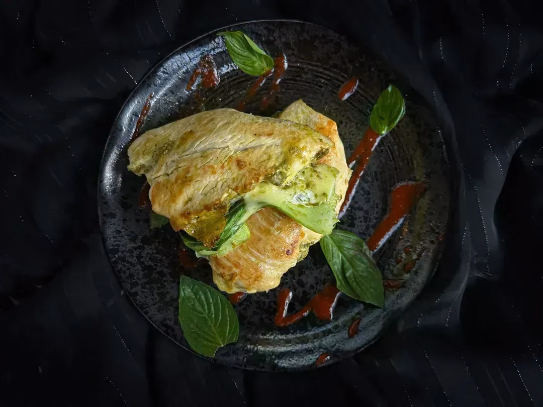 In a blue dish, there are two beautiful chicken cutlets.