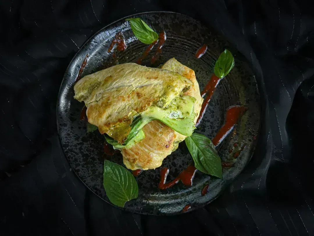 In a blue dish, there are two beautiful chicken cutlets.