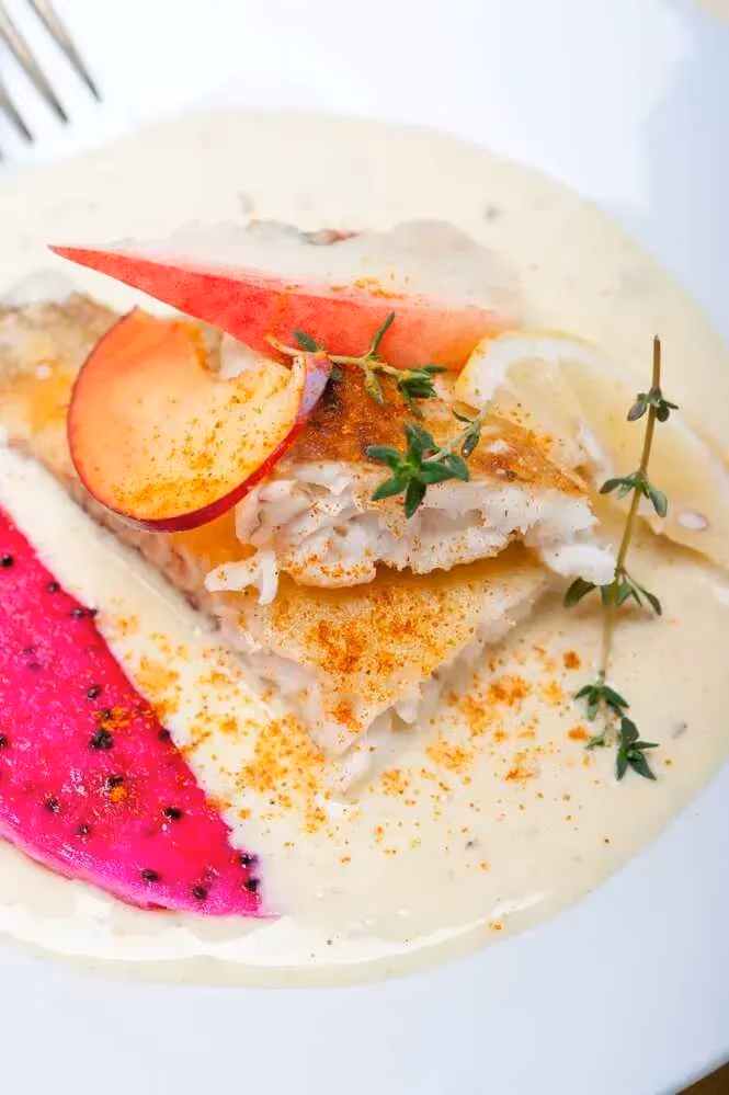 Vanilla sea bream fillets are plated on a white plate.