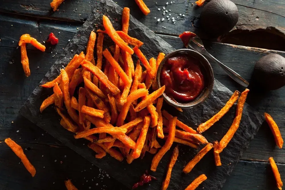 Orange-fleshed sweet potato fries, enhanced with paprika, show off their most beautiful colors.