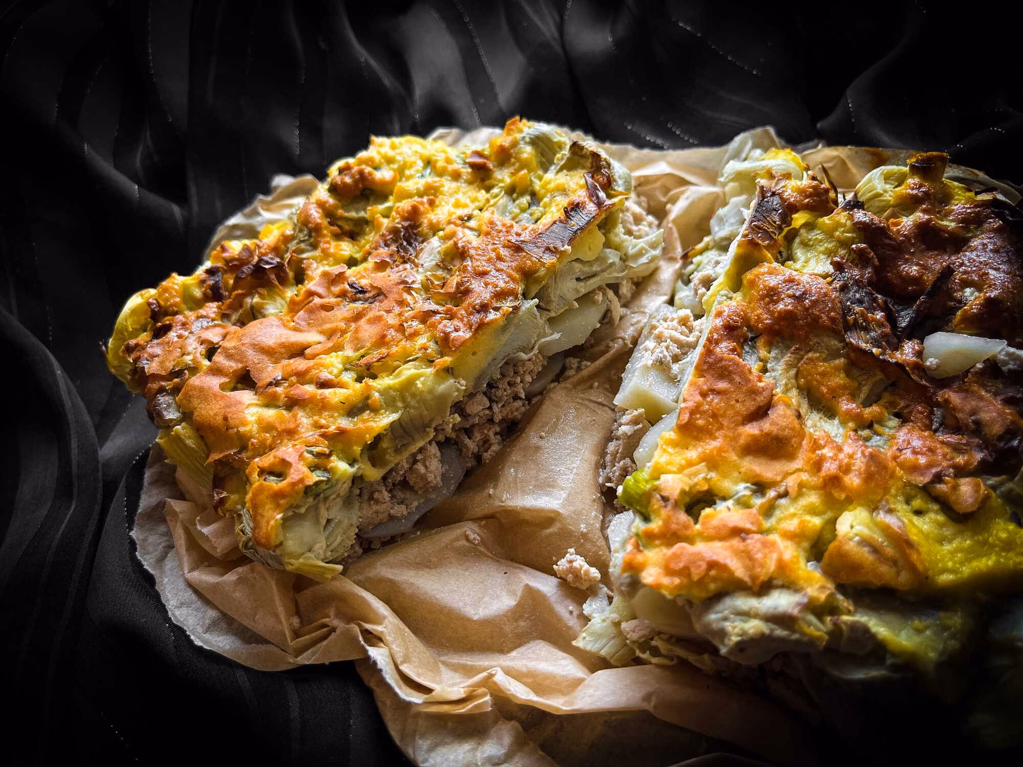 Two huge slices of artichoke, potato, and grated tofu gratin are served up for a true feast for the senses!