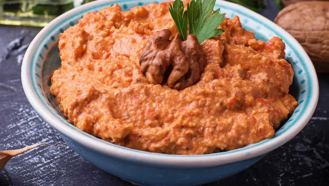 In a large blue-and-white bowl is the spread called Ktipiti. Its beautiful orange color comes from the paprika.