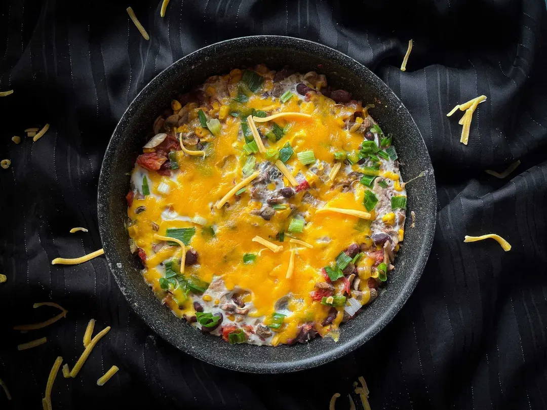 The Mexican-style eggs recipe is presented in a blue bowl.