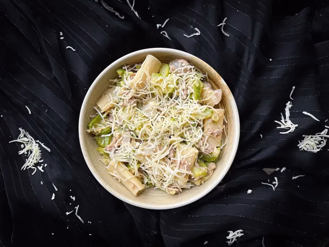 In a saucepan are the penne that form the base of this one-pot pasta with tuna, zucchini, and Gruyère.