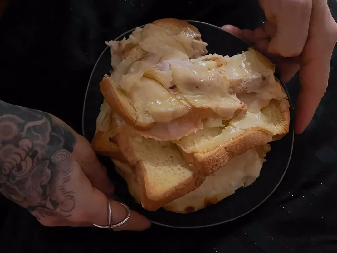 Savory baked French toast is in a small blue bowl.