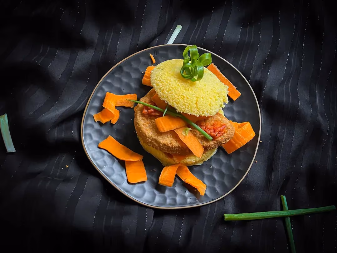 A small blue textured bowl holds the veggie burger.