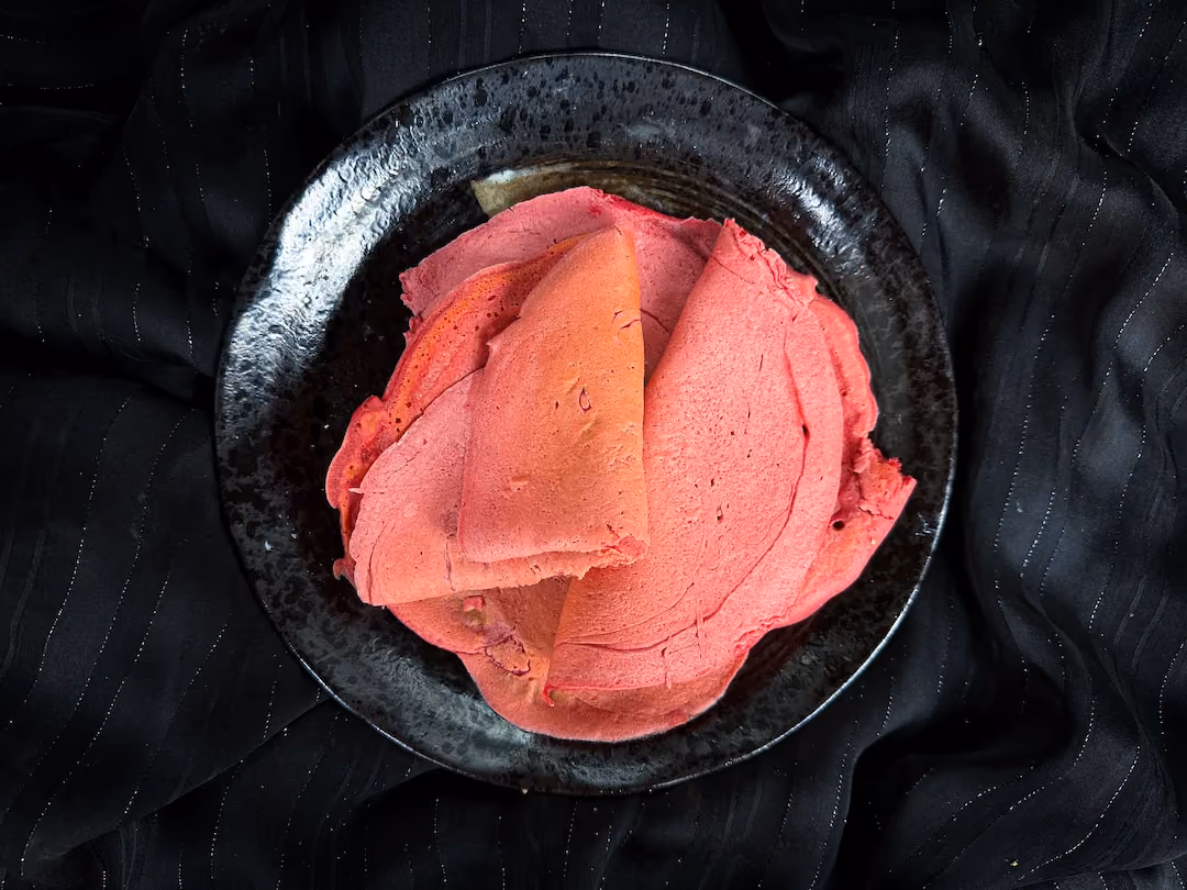 The pink wraps are presented in a small blue earthenware bowl.