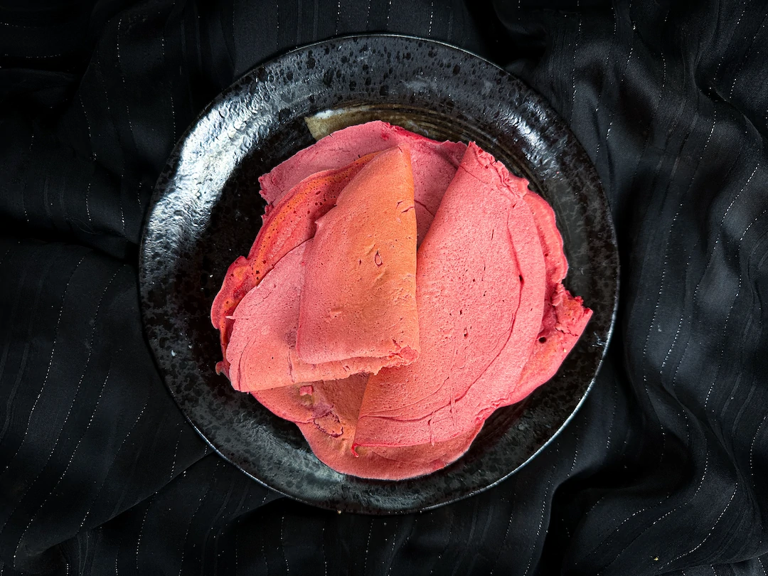 Les wraps roses sont présentés dans un petit saladier en faïence de couleur bleu.