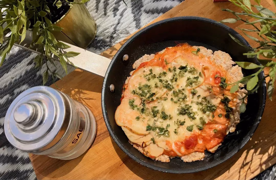 Presented in the skillet it was cooked in, this mouthwatering pizza is just waiting to be eaten.