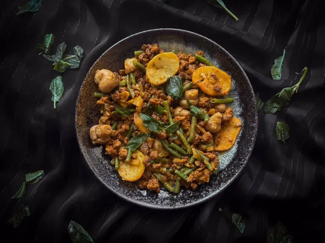 The forest-style skillet with button mushrooms and plant-based ground meat is presented in a small blue bowl.