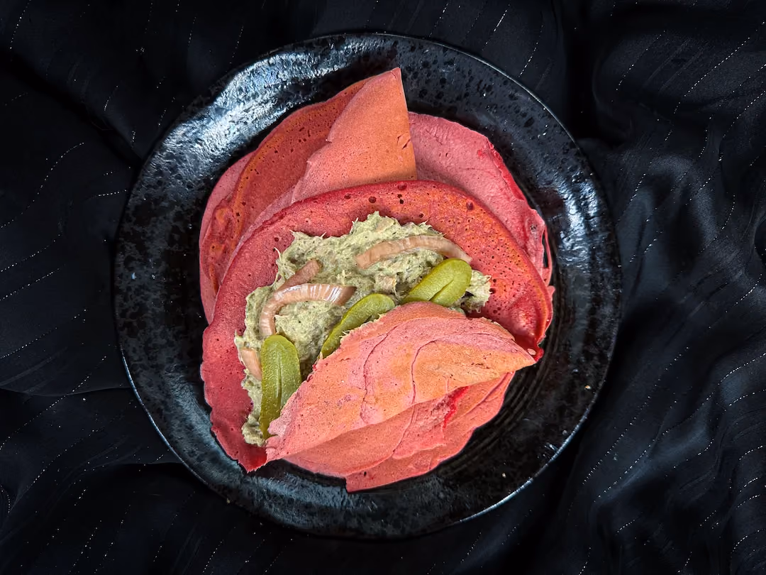 In a small bowl, there are pink wraps served with tuna rillettes with pesto.