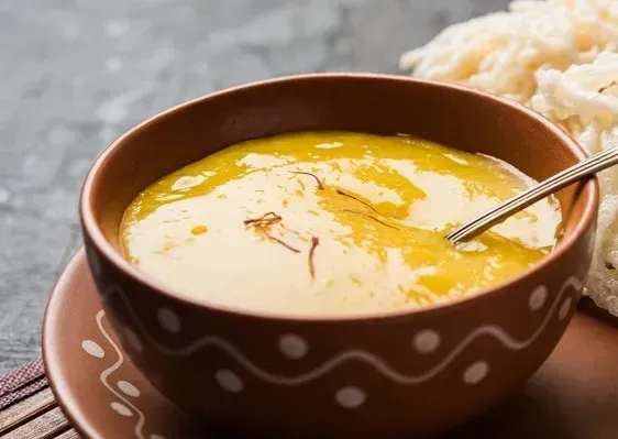 The exotic salad dressing is presented in a beautifully decorated brown bowl.