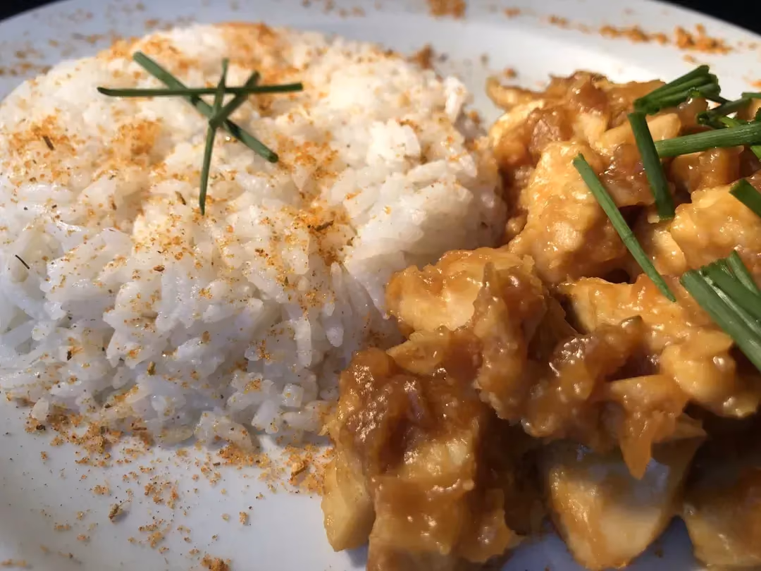In a large white dish, you can see the side of rice on one side and the soy on the other. The whole dish is sprinkled with finely chopped chives.