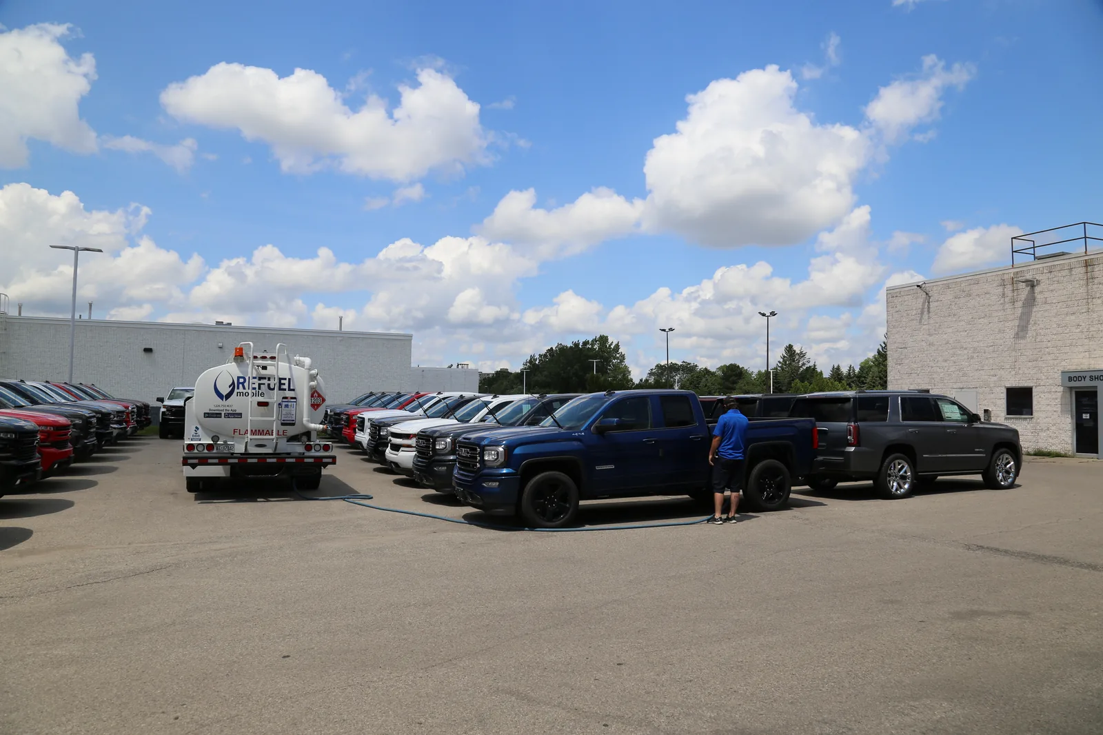 A Refuel Mobile fuel truck servicing multiple vehicles parked across a customer yard
