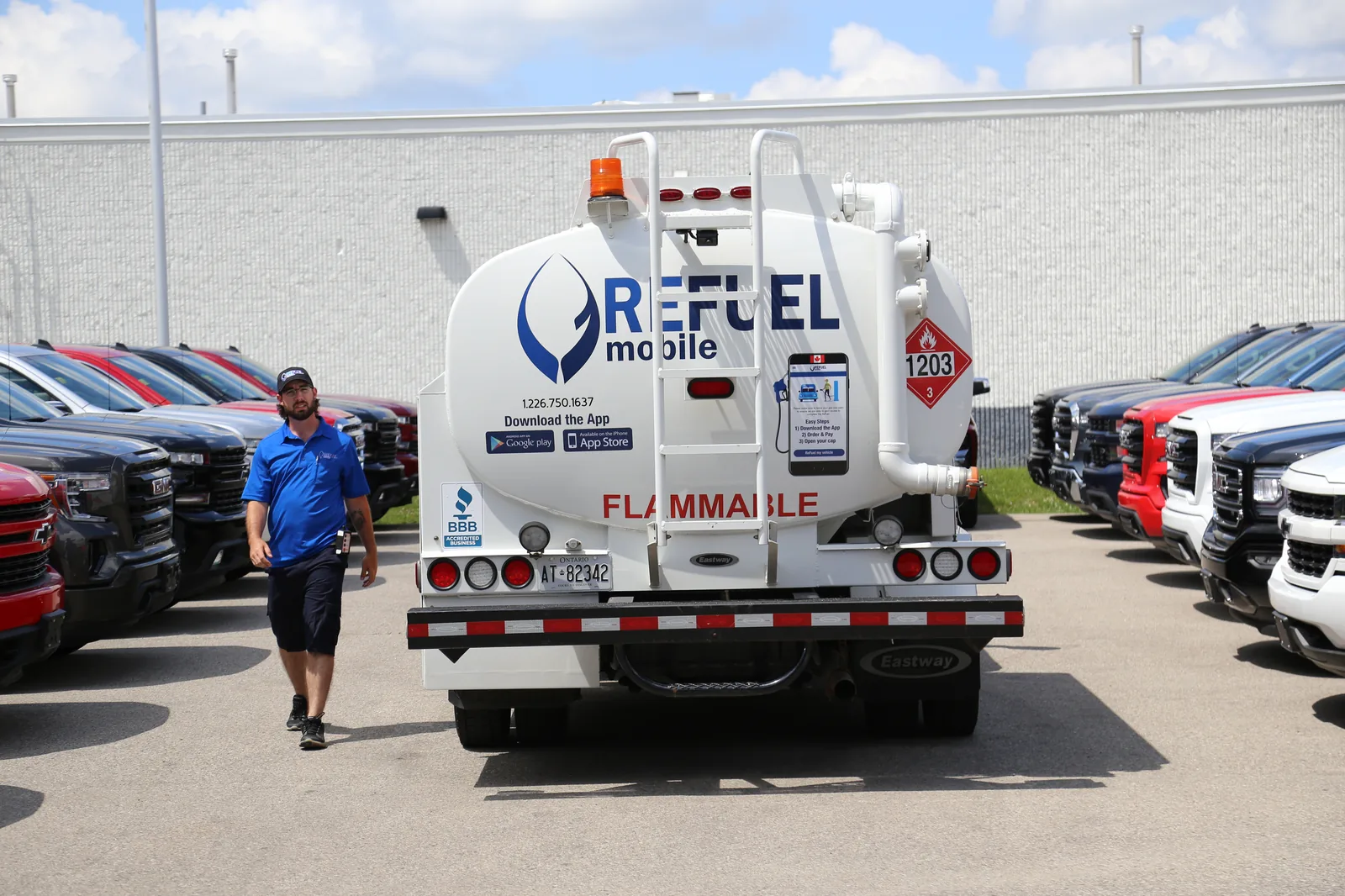 Rear view of a Refuel Mobile tanker truck displaying a TDG placard 1203 and flammable marking