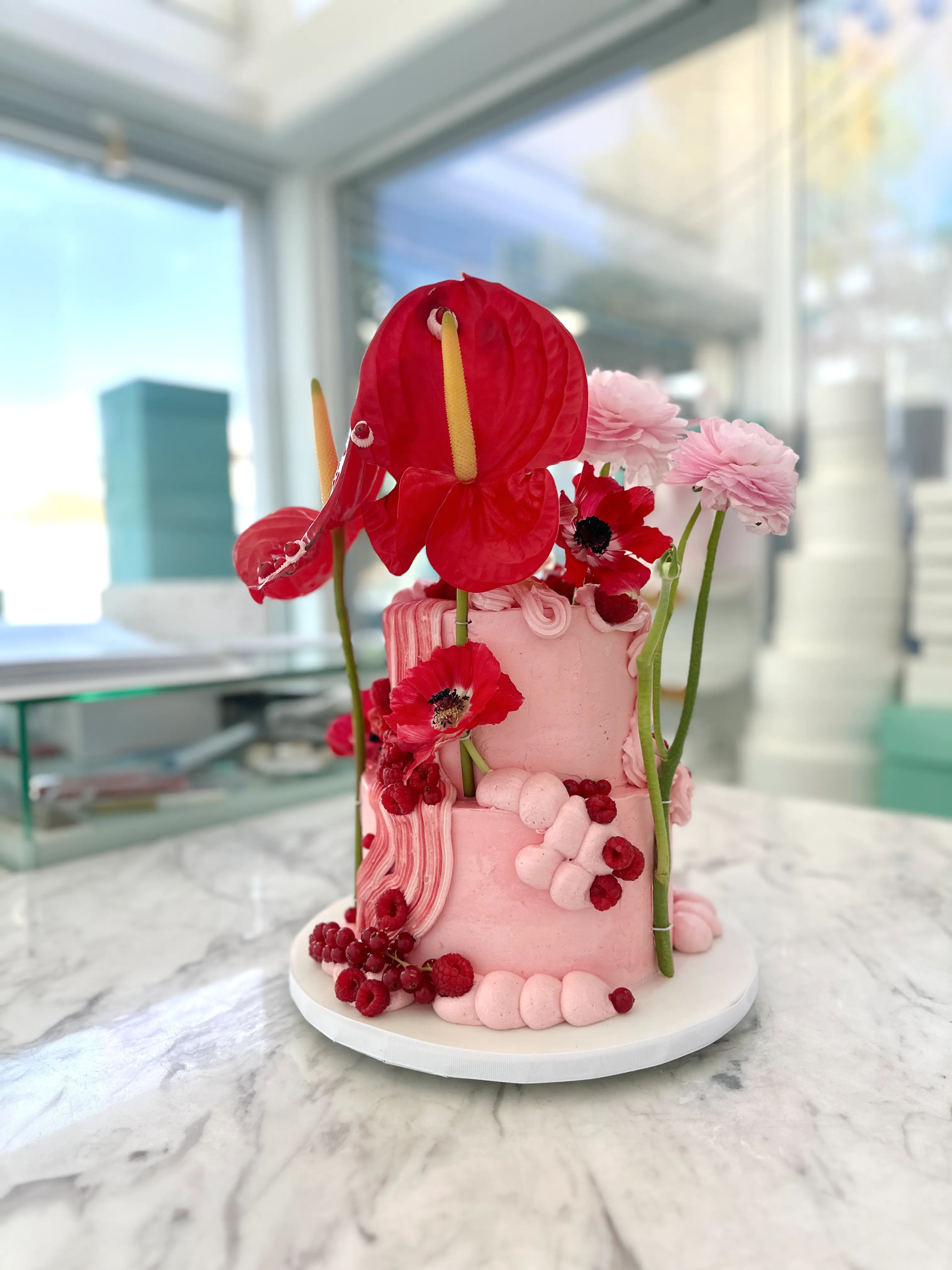 Romantic pink and red birthday cake with fresh flowers and berries, feminine luxury cake design for woman in cyprus
