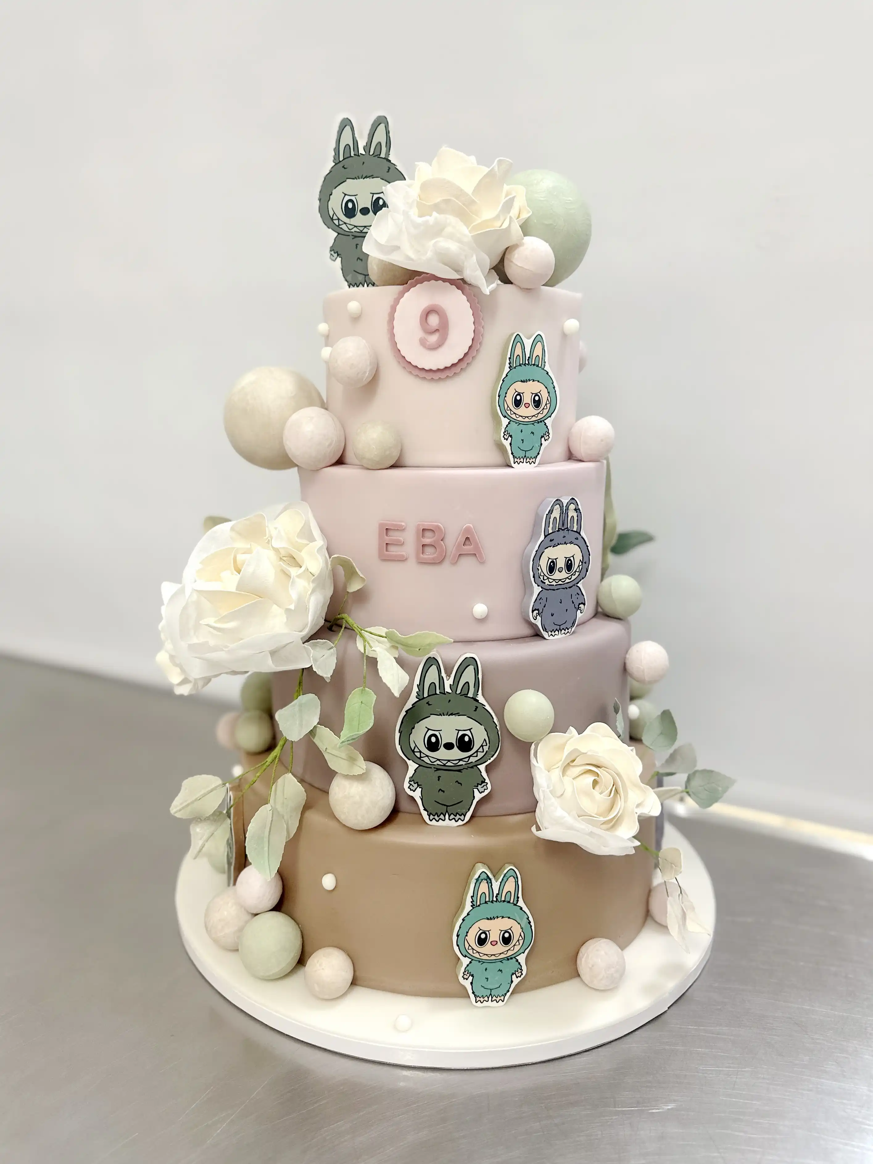 Luxury tiered labubu birthday cake for girl with sugar flowers and cute character decorations, bespoke designer cake in cyprus