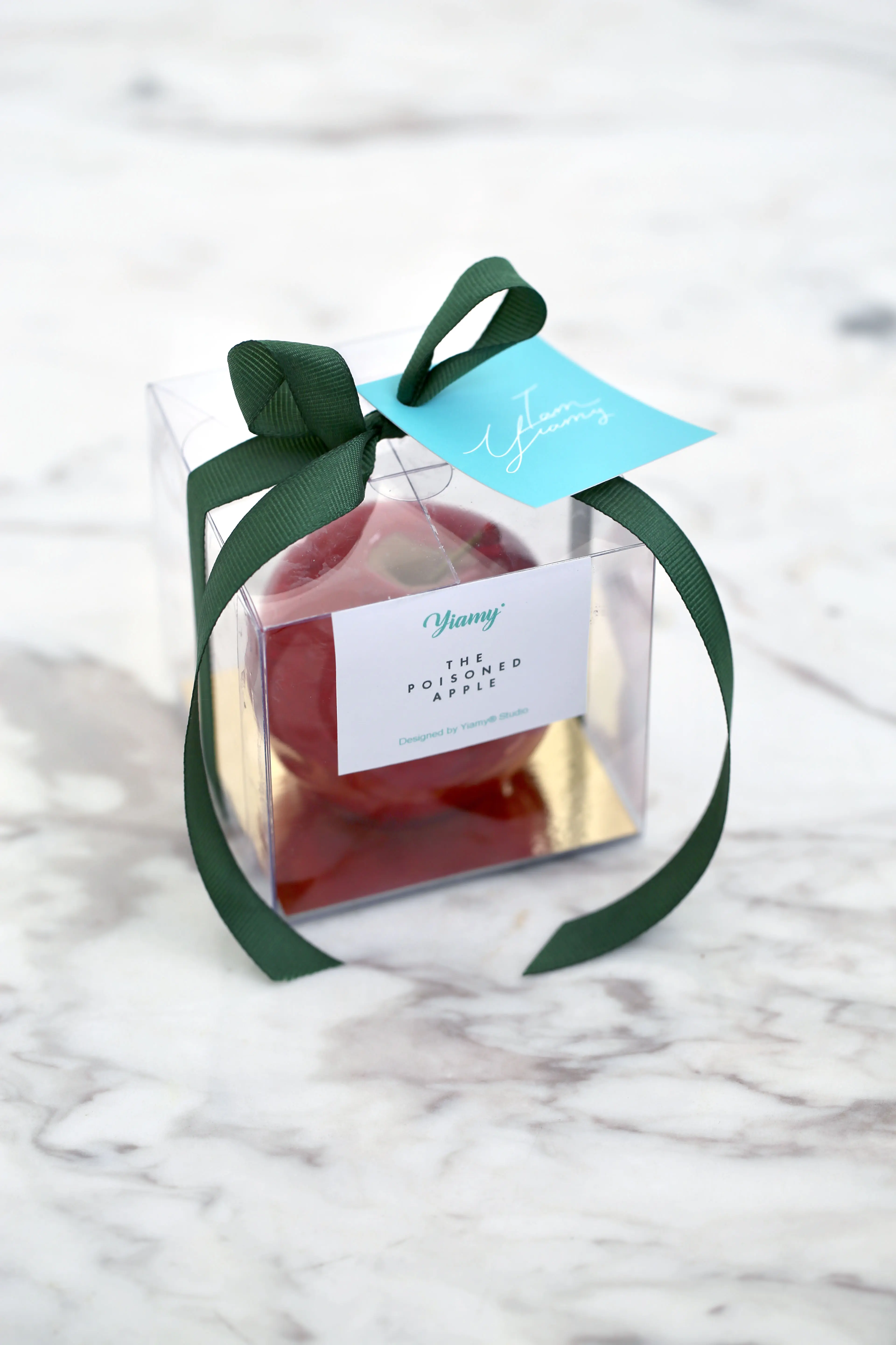 Luxury candy apple dessert favour in a transparent gift box with a dark green ribbon, featuring a glossy red apple design, ideal for stylish event gifting and special occasions in Limassol Cyprus