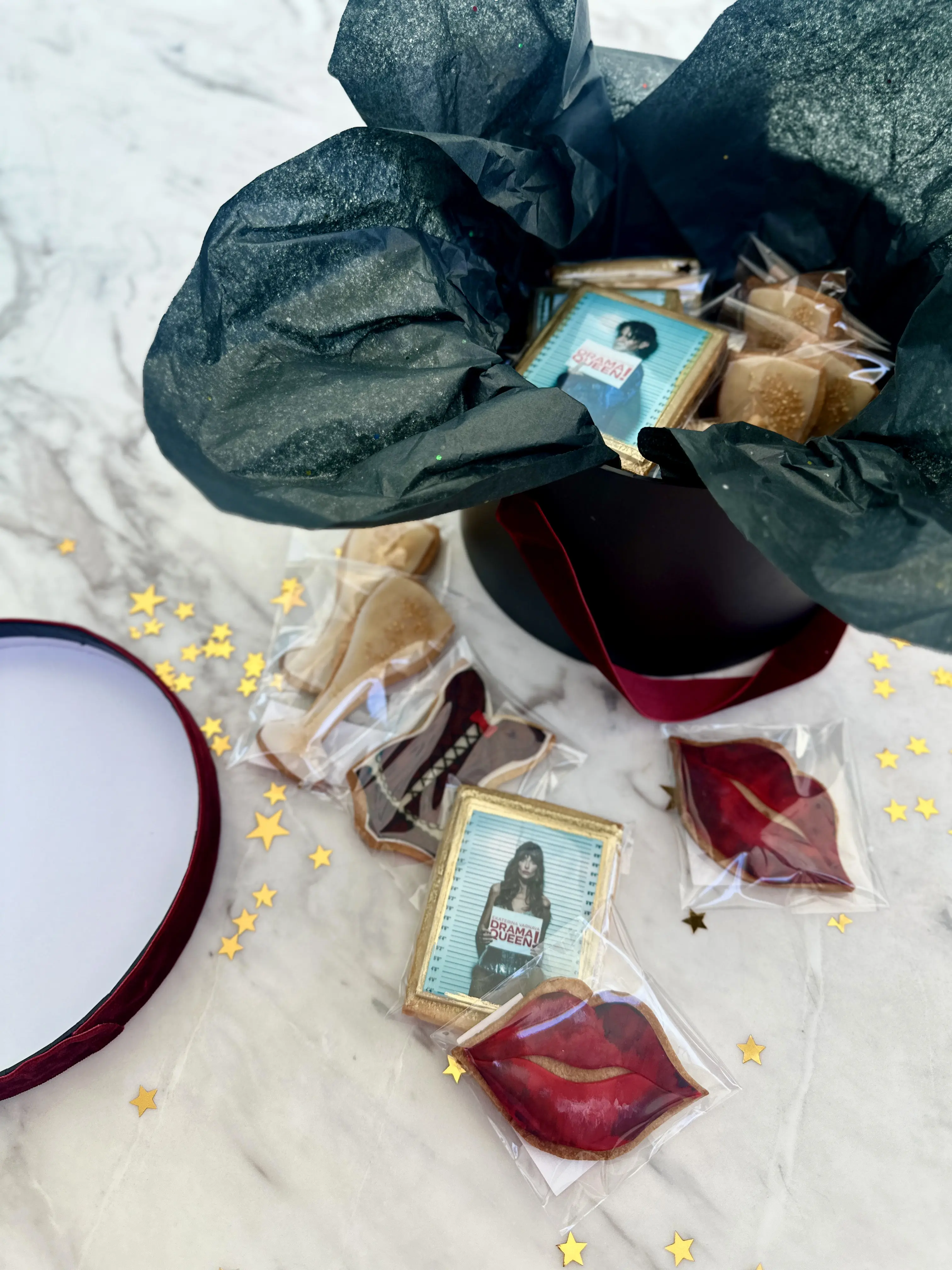 Premium corporate gift box for Ekaterina Varnava in limassol cyprus featuring custom decorated cookies, including illustrated portrait cookies, lips and themed designs, elegantly packaged with black tissue paper for luxury gifting