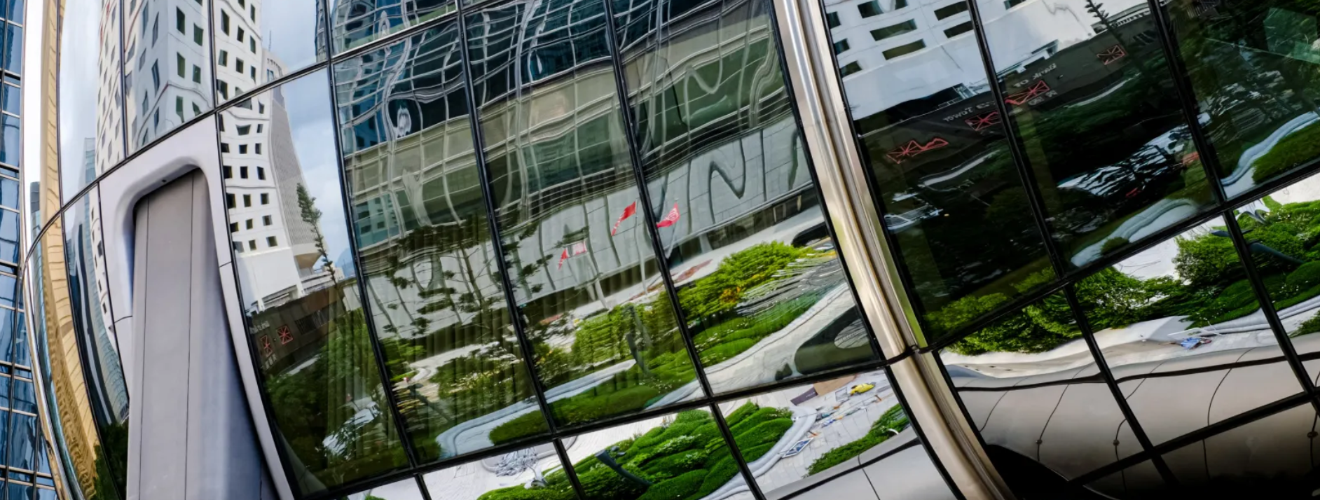 Abstract reflection of modern office buildings representing the complexity and hidden risks of enterprise AI deployment.
