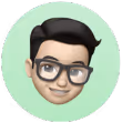 3D avatar of a person with black hair, glasses, and a light green circular background.