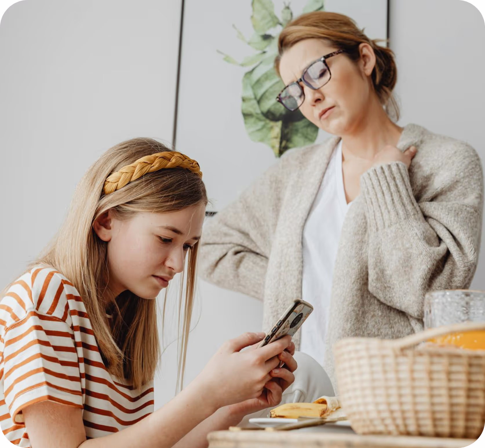 A girl with cell-phone and her mum