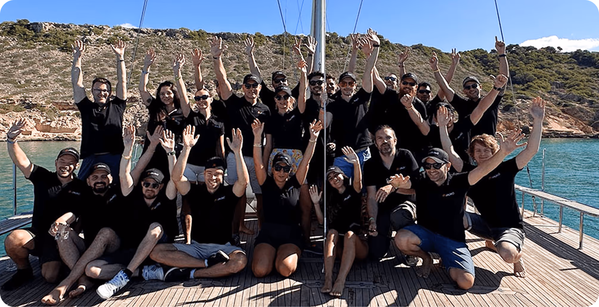 WeightBuddy team celebrating together on a boat with arms raised, showing the company's friendly, supportive culture