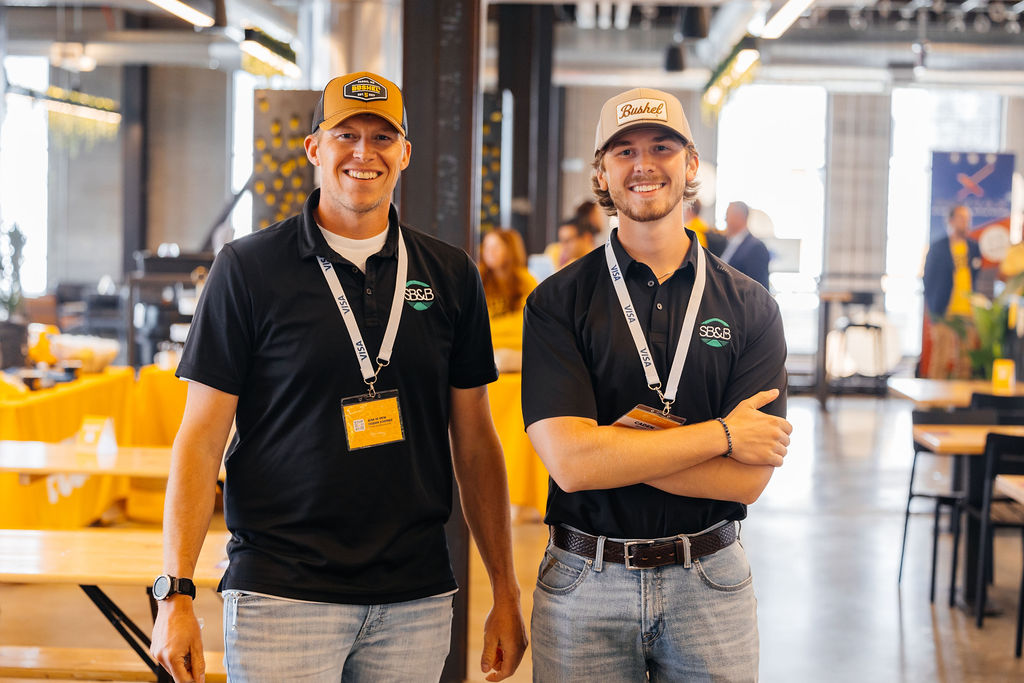 Two staff members smiling