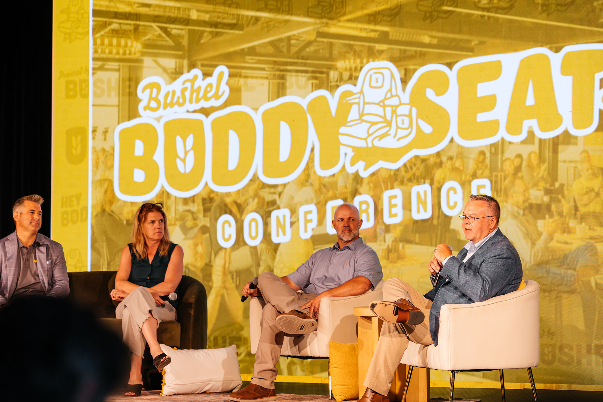 Four people talking on stage