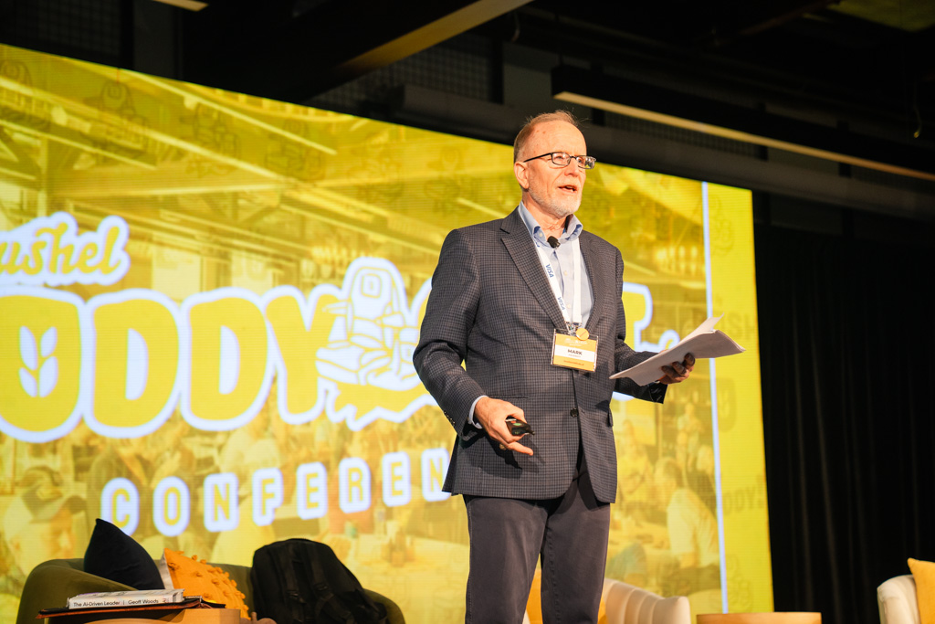 Person speaking in front of a crowd